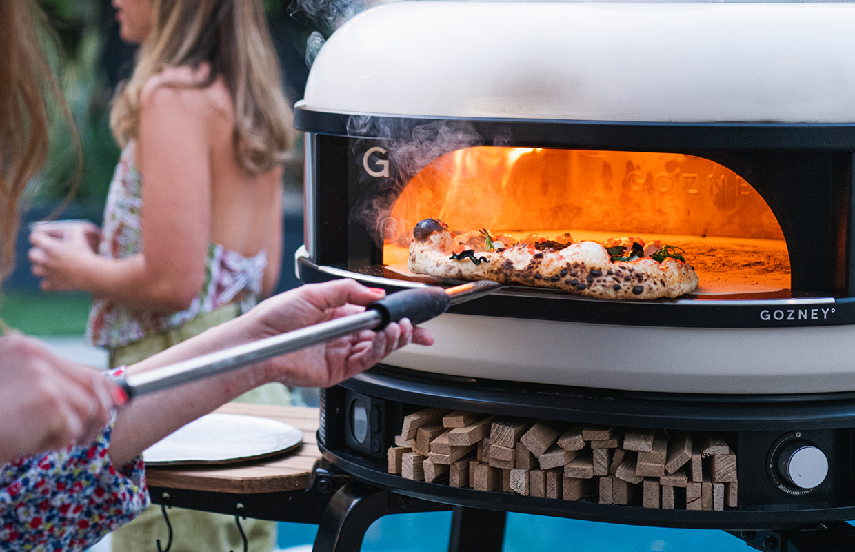 Pizza being loaded into Dome Pizza Oven
