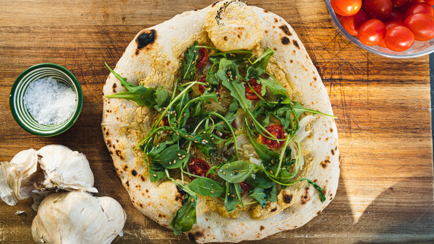 Hummus Pizza with side of tomatoes and garlic recipe poster image