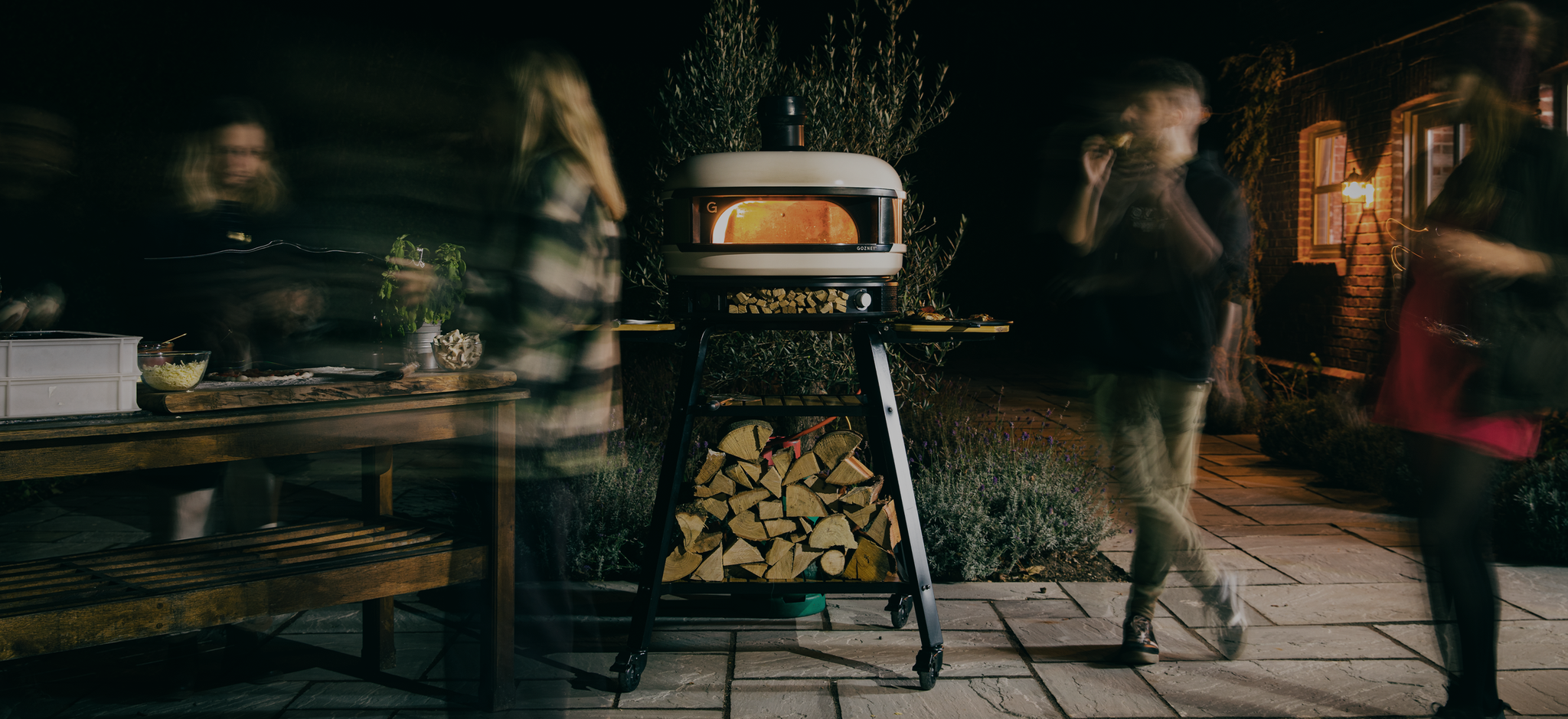 Outdoor pizza party at night with Dome Pizza Oven