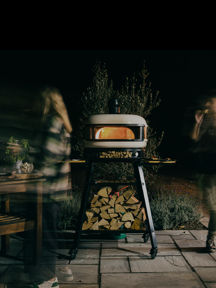 Outdoor pizza party at night with Dome Pizza Oven