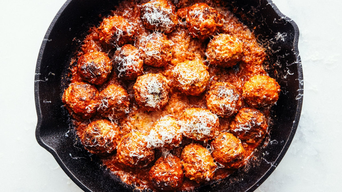 Wood-Fired meatballs in a cast iron skillet.