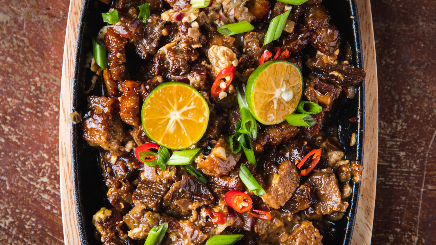 Pork Belly Sisig served on hot skillet recipe poster image